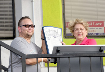 Mayor Pro Tem Ellen Cohen and Lou Weaver, co-chair of Houston's LGBTQ Advisory Board, hold up an  "Orlando United" proclamation during a vigil for the Pulse victims at the Montrose Center on Monday. 