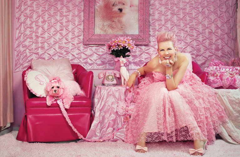 Pretty in pink: Kitten Kay Sera poses with Miss Kisses, her pet Maltese, in her pink place.