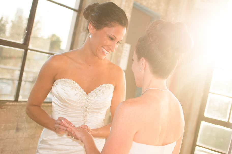 Brides Sarah and Carrie exchange elegant engagement rings from Zadok Jewelers. Photo: Sebastian Aguilar