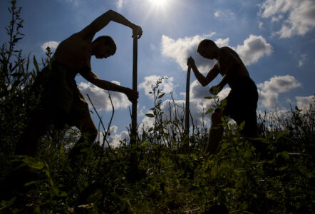 Young men who grew up in the home tend the fields of in the agriculture program at Casa Ashitanoie.