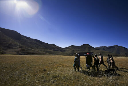 Villagers carry the remains of a man who died after being transported from the mountains by Missionary Air Fellowship, or MAF, to the main hospital in the capitol of Maseru, Lesotho, and was then transported back home by the same pilots after passing.