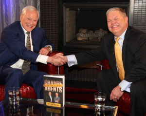 Book him: David Lorms (r) shakes hands with Brian Tracy, author of Change Agents. Lorms is a featured business expert in the book.